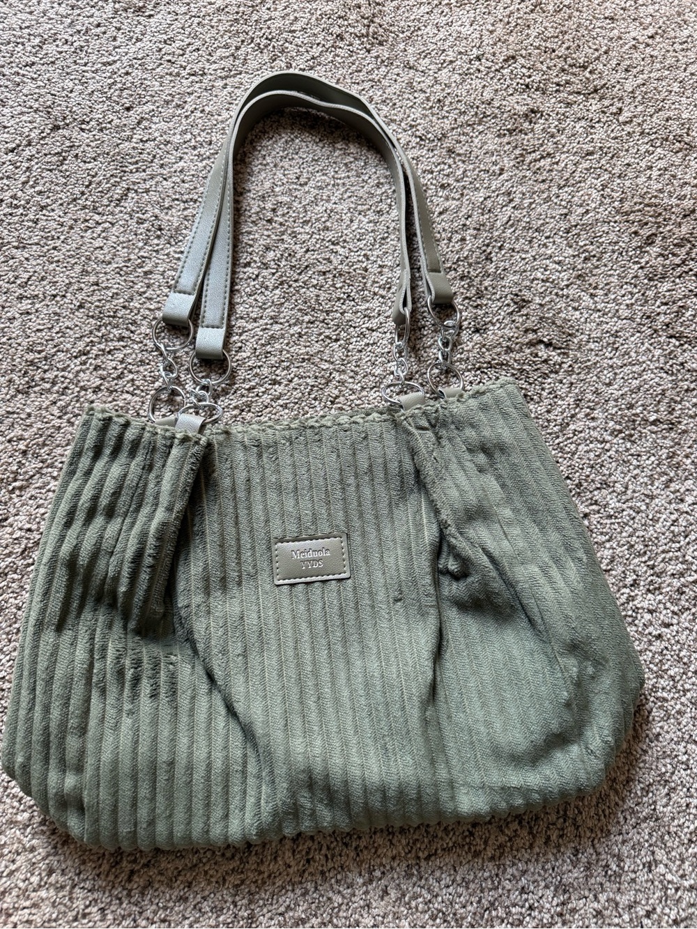 New in pkg. Corduroy type material.  Sage green ladies handbag.